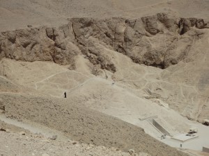 A lone black-robed hawker on a hill above the Valley of the Kings