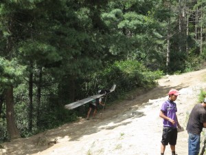 A Sherpa porter carriers building supplies up in to the mountains