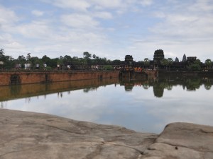 At the western entrance to Angkor Wat, looking across the moat