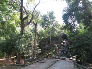 The remains of a once-proud entranceway, now collapsed and blocking the path