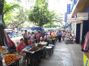 Street vendors in Yangon.  Those piles of brown things are crickets.  Tasty!
