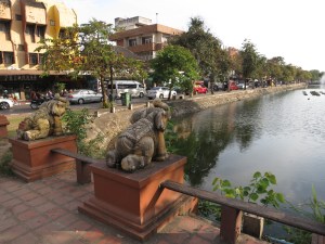 Statue elephants gaze along the moat that surrounds the square centre of Chiang Mai